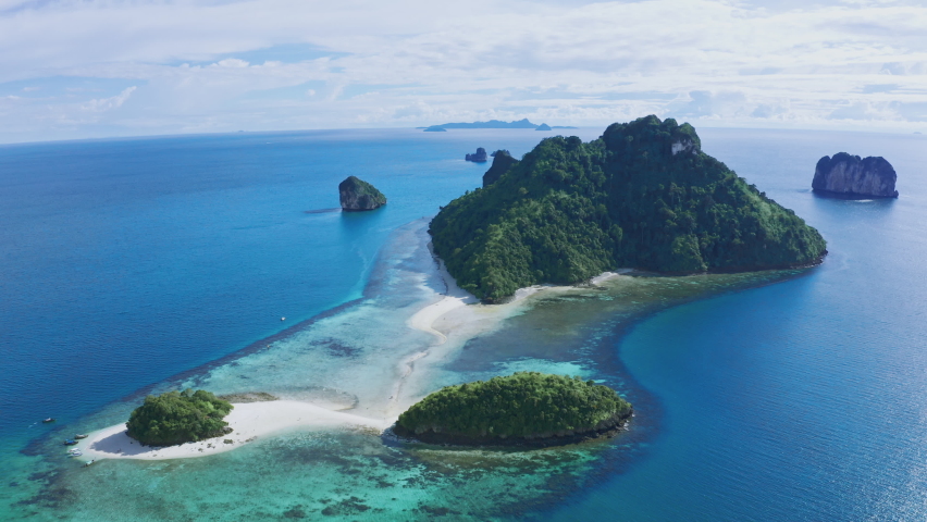 Aerial view of Separated sea near railay beach Landmark of Krabi, Thailand. Drone shot over chicken island in andaman sea with beautiful blue turquoise seawater. Tourist attraction in summer holidays. Royalty-Free Stock Footage #1091572459