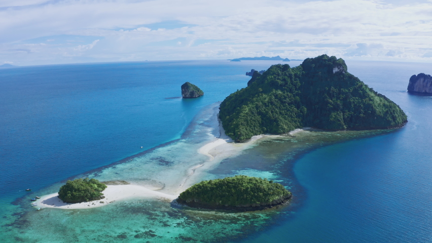 Aerial view of Separated sea near railay beach Landmark of Krabi, Thailand. Drone shot over chicken island in andaman sea with beautiful blue turquoise seawater. Tourist attraction in summer holidays. | Shutterstock HD Video #1091572459