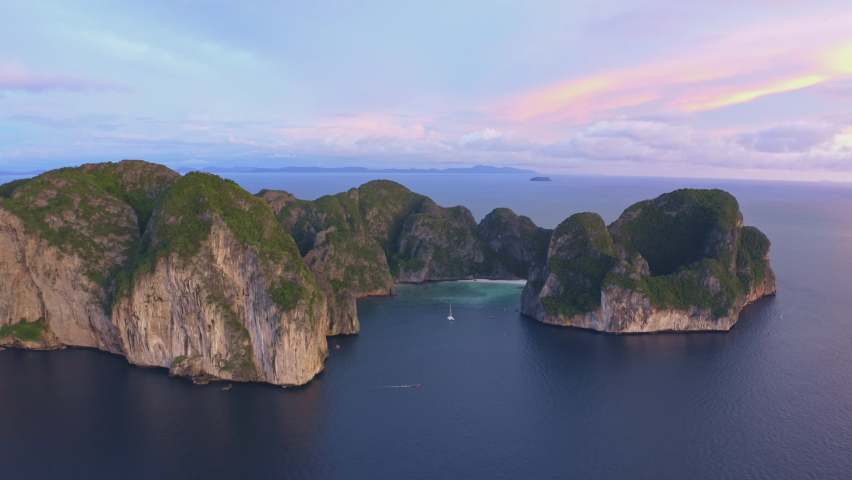 Aerial view of Phi Phi islands Travel Landmark of Krabi Phuket, Thailand. Amazing Drone shot over Maya beach with beautiful blue turquoise seawater in twilight. Tourist attraction in summer holidays. | Shutterstock HD Video #1091572461