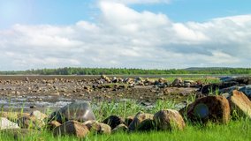 Karelian landscape with clouds and stones. 4K time lapse with lens flare 
