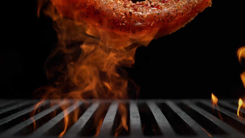 Marinated and Seasoned Chicken Breast Falling onto the Grill Grate Flaming in Slow Motion - BBQ on Black Background Royalty-Free Stock Footage #1091583503