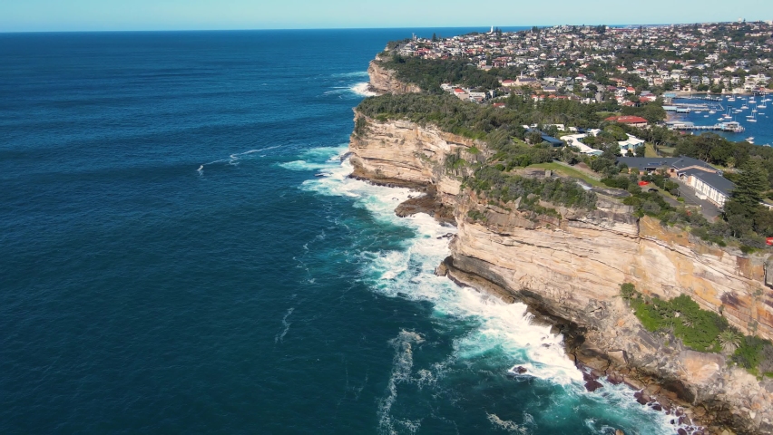 Aerial drone view of Watsons Bay in East Sydney, Australia heading south along the coastal clifftop and walkway on a sunny day Royalty-Free Stock Footage #1091585425