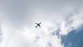 Passenger plane flying in the clouds. 4x slow motion video