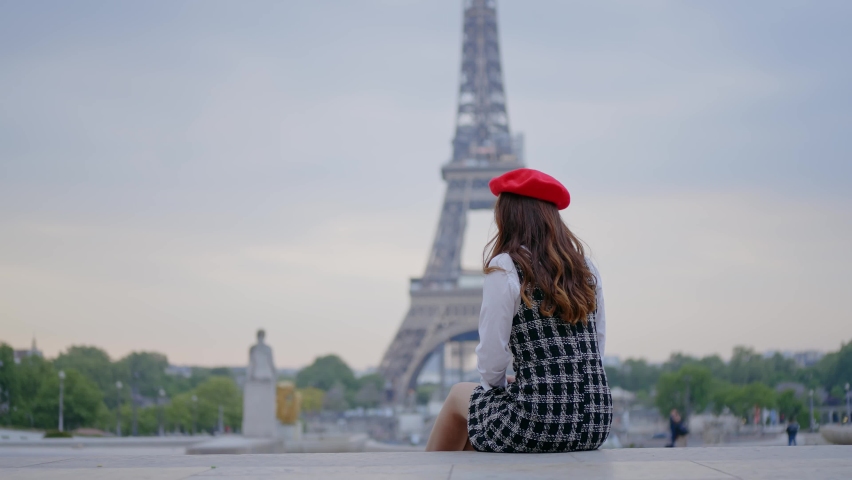 Cinematic footage of a young woman wearing fashionable clothes having fun in Paris at the eiffel tower park and streets. Concept about european tourism and travels to the capital cities | Shutterstock HD Video #1091594379