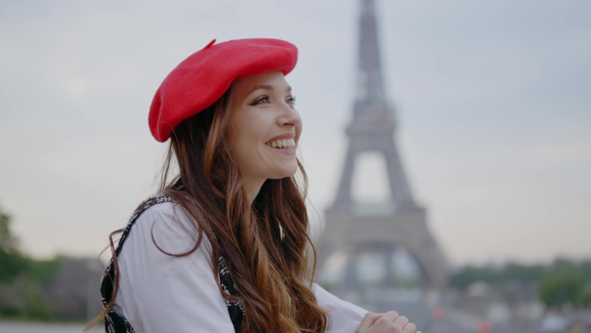 Cinematic footage of a young woman wearing fashionable clothes having fun in Paris at the eiffel tower park and streets. Concept about european tourism and travels to the capital cities | Shutterstock HD Video #1091594389