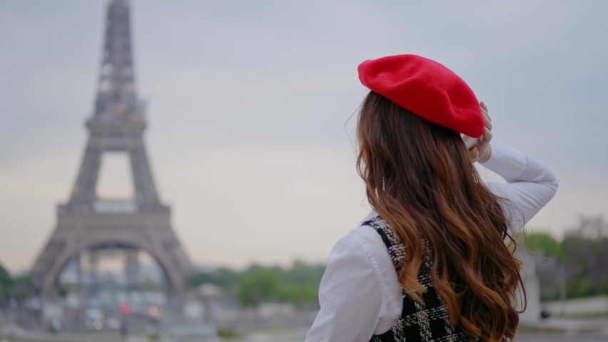 Cinematic footage of a young woman wearing fashionable clothes having fun in Paris at the eiffel tower park and streets. Concept about european tourism and travels to the capital cities | Shutterstock HD Video #1091594397