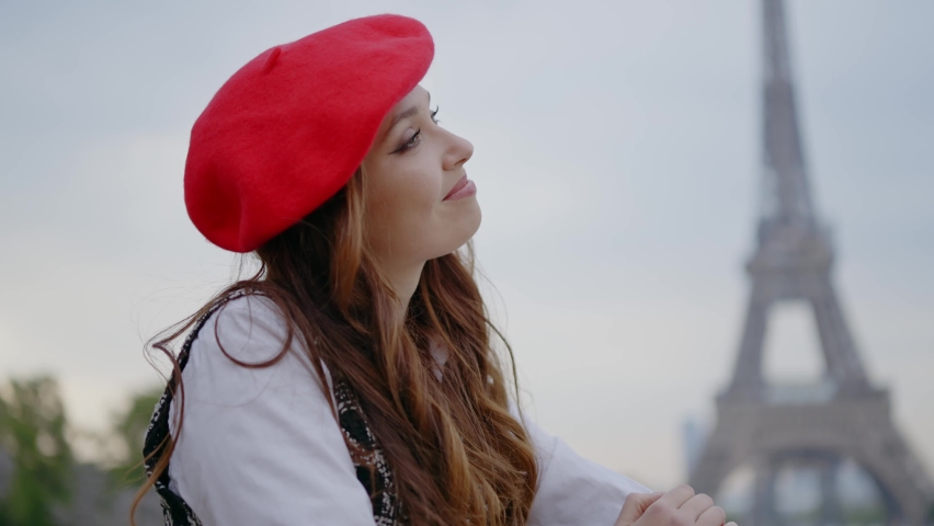 Cinematic footage of a young woman wearing fashionable clothes having fun in Paris at the eiffel tower park and streets. Concept about european tourism and travels to the capital cities | Shutterstock HD Video #1091594399