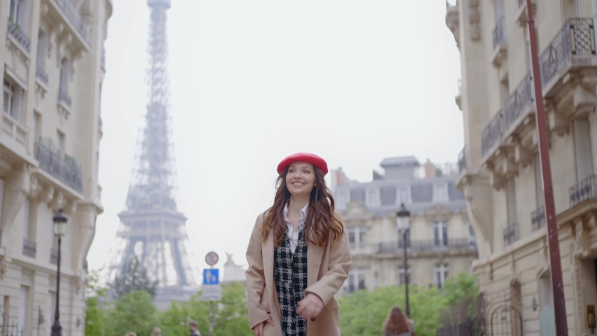 Cinematic footage of a young woman wearing fashionable clothes having fun in Paris at the eiffel tower park and streets. Concept about european tourism and travels to the capital cities | Shutterstock HD Video #1091594403