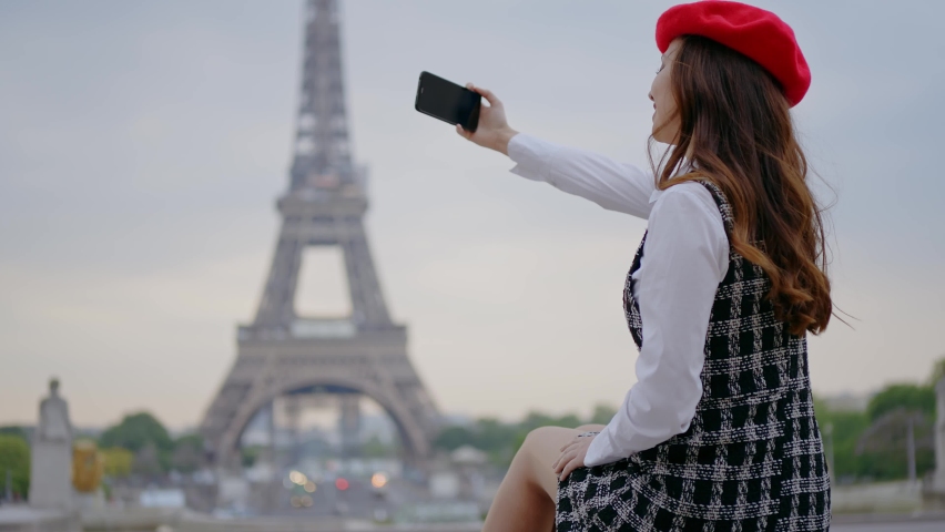 Cinematic footage of a young woman wearing fashionable clothes having fun in Paris at the eiffel tower park and streets. Concept about european tourism and travels to the capital cities | Shutterstock HD Video #1091594405