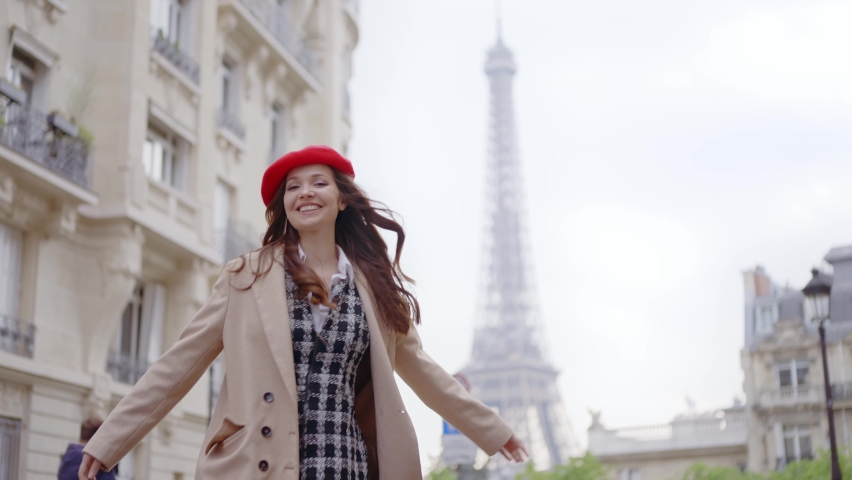 Cinematic footage of a young woman wearing fashionable clothes having fun in Paris at the eiffel tower park and streets. Concept about european tourism and travels to the capital cities | Shutterstock HD Video #1091594409