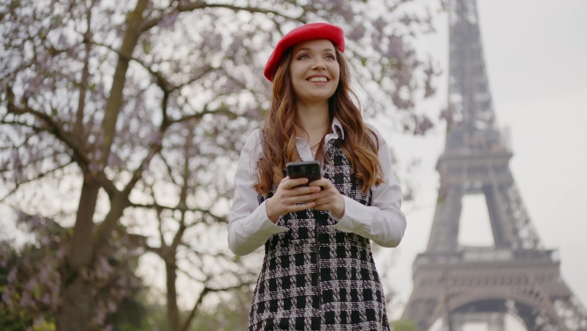 Cinematic footage of a young woman wearing fashionable clothes having fun in Paris at the eiffel tower park and streets. Concept about european tourism and travels to the capital cities | Shutterstock HD Video #1091594413