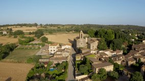 Aerial drone video footage of Spanish city Pubol. camera zooms in on the cathedral in the center. small town located in the municipality of La Pera province of Girona, Catalonia. Top view from above