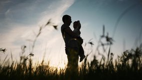 father and son silhouette. happy family kid dream concept. father holding in his arms in the grass in nature at sunset shadow silhouette. fathers day. father and son in the park sunset silhouette - Powered by Shutterstock - Get 15% off with code: PIKWIZARD15