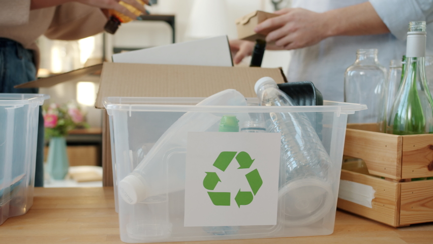 Close-up of recycling containers and hands male and female sorting out garbage at home. Environment protection and zero waste concept. | Shutterstock HD Video #1091600187