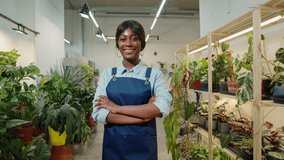Florist African American woman portrait, flower shop. Greenhouse worker smiling, happy botanist close-up, small business owner. Gardener working in plant store.  - Powered by Shutterstock - Get 15% off with code: PIKWIZARD15