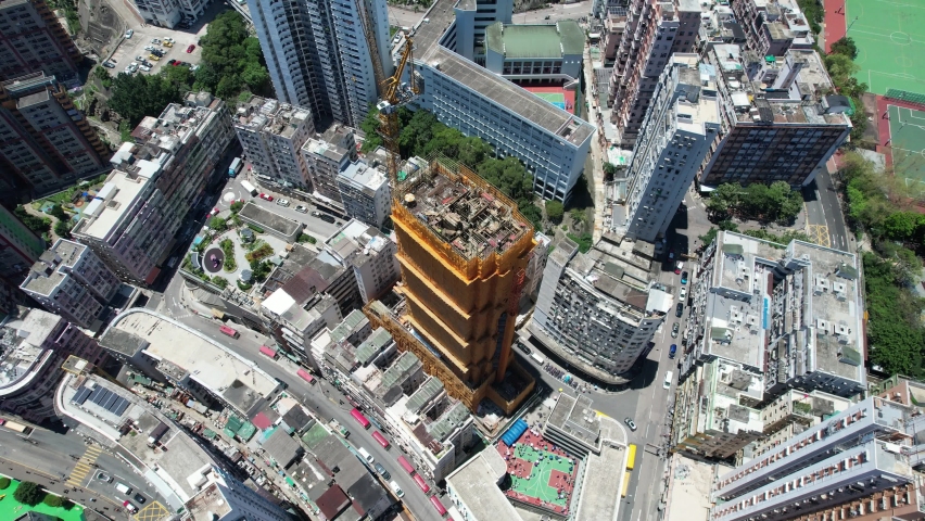 Commercial and residential construction development project in Kwun Tong of Hong Kong city, becoming the newest business district near Kowloon Bay and Victoria harbor, Aerial drone skyview | Shutterstock HD Video #1091601843