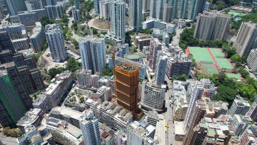 Commercial and residential construction development project in Kwun Tong of Hong Kong city, becoming the newest business district near Kowloon Bay and Victoria harbor, Aerial drone skyview | Shutterstock HD Video #1091601859