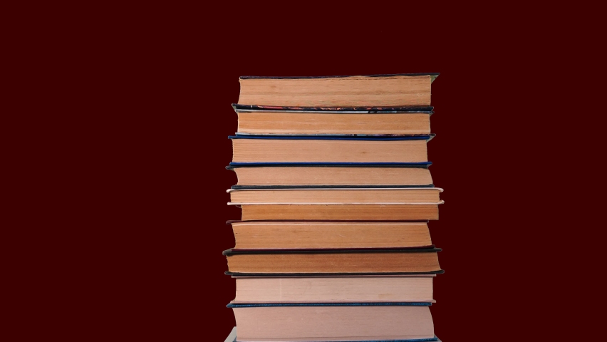 Books one by one, the stack of books grows. Learning and exam preparation concept. Library of scientific or fiction books. Stop motion. | Shutterstock HD Video #1091602097