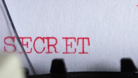 Typing "top secret" on an old electric typewriter