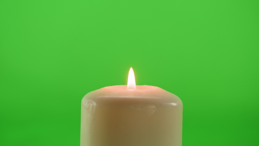 Burning wax candle on green chroma key background. Fire flame candlelight close-up. | Shutterstock HD Video #1091604641