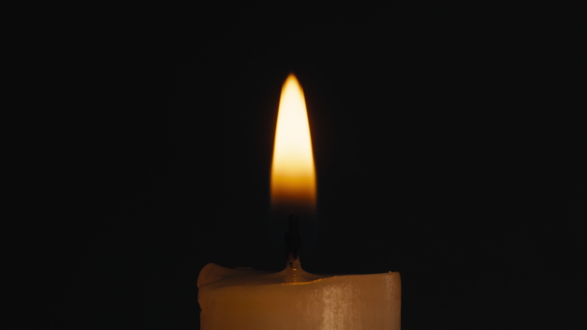 Burning wax candle on black chroma key background. Fire flame candlelight close-up. | Shutterstock HD Video #1091604649