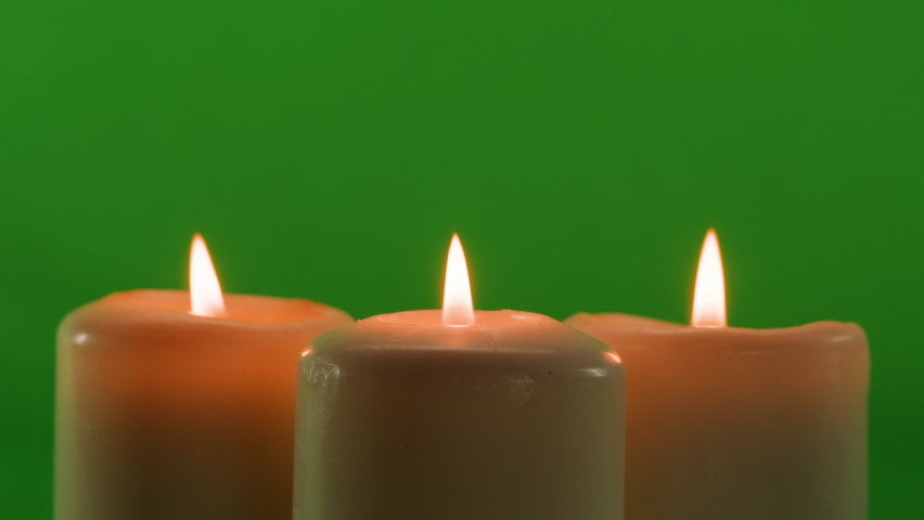 Burning wax candles on green chroma key background. Fire flame candlelight close-up. | Shutterstock HD Video #1091604663