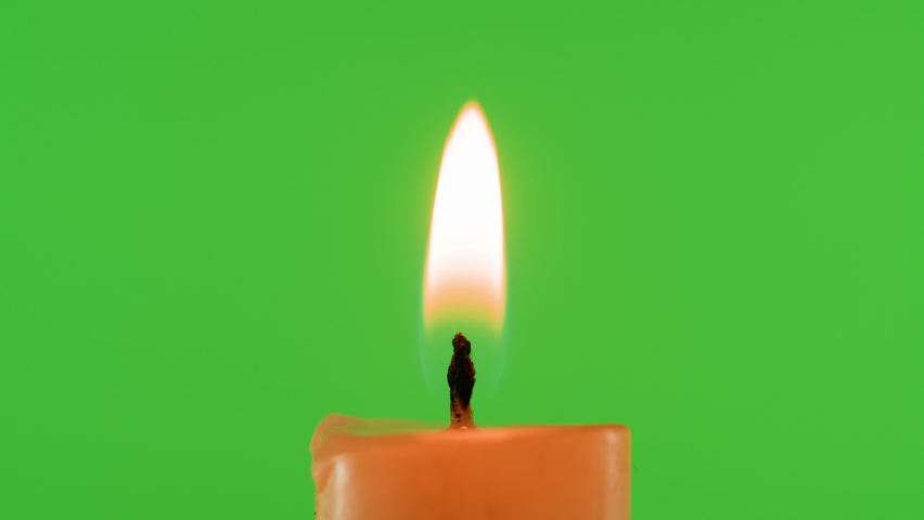 Burning wax candle on green chroma key background. Fire flame candlelight close-up. | Shutterstock HD Video #1091604665