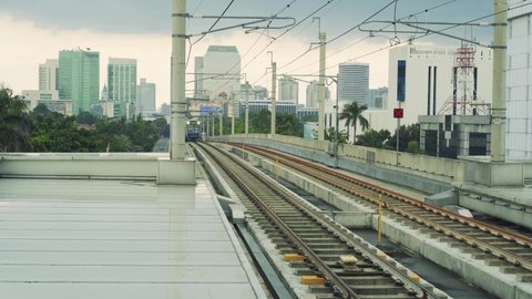 JAKARTA, INDONESIA - NOVEMBER 20, 2021: An MRT train came from the direction of Bundaran HI station and entered the ASEAN station on a cloudy afternoon.