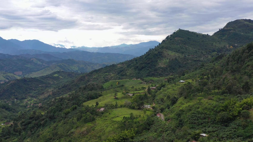 4K aerial shot, drone flying over green mountains at Antioquia Andes region in Colombia. Cloudy day. Royalty-Free Stock Footage #1091607039