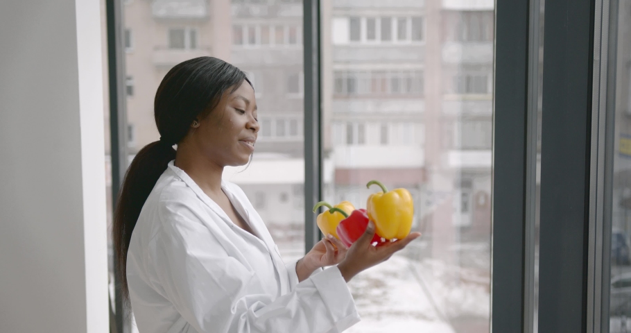 Nutritionist holding fresh peppers in hands