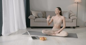 Fir young woman doing stretching exercises at home