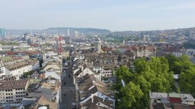 Inscription on video. Zurich, Switzerland. Panorama of the city from the air. Urania Sternwarte Observatory, Lindenhof City Park. Arises from blue water, Aerial View