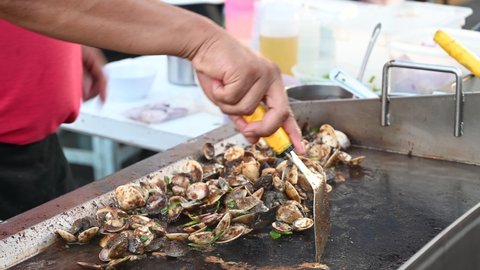 Melaka  Malaysia - 25th June 2022: A man is preparing food at Jonker Street.