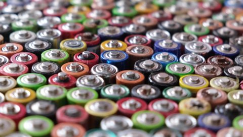 Close up top view of rows of AA energy batteries abstract background of colorful batteries.