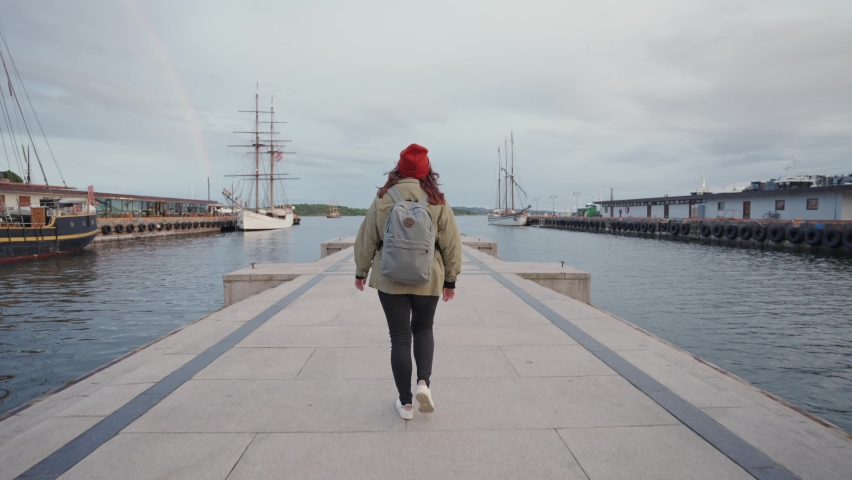 Young woman tourist sightseeing in the city. Traveler walking in the old town on vacation. The concept of holidays, wanderlust and travel. Slow motion | Shutterstock HD Video #1091615203
