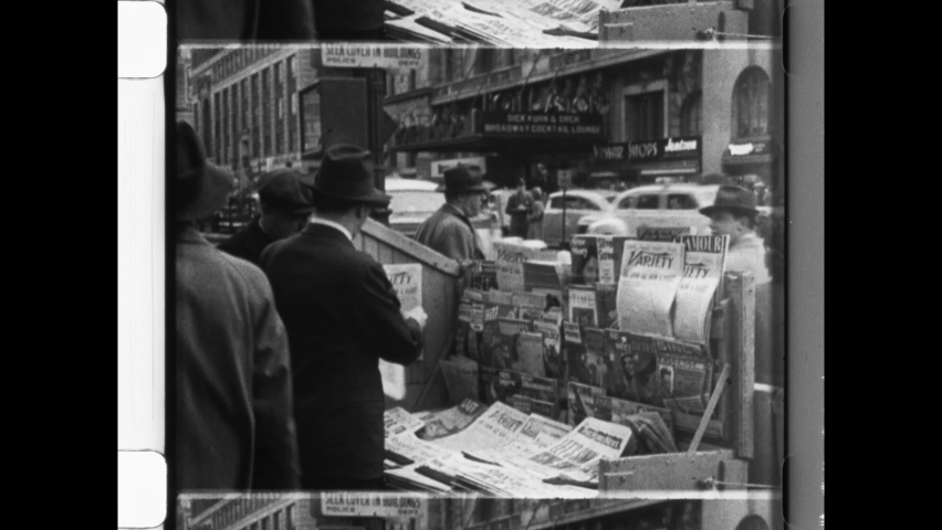 1942 NYC. Man buys Variety Newspaper from Newsstand. New York City Street Scene. Man pays for newspaper from vendor. World War 2 travels via newspaper. 4K Overscan of Vintage Archival Newsreel 