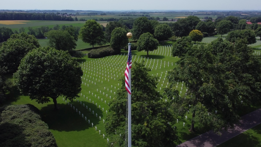 White Crosses at American flag at Military Cemetery in Margraten, Limburg, The Netherlands. Second World War Cemetery