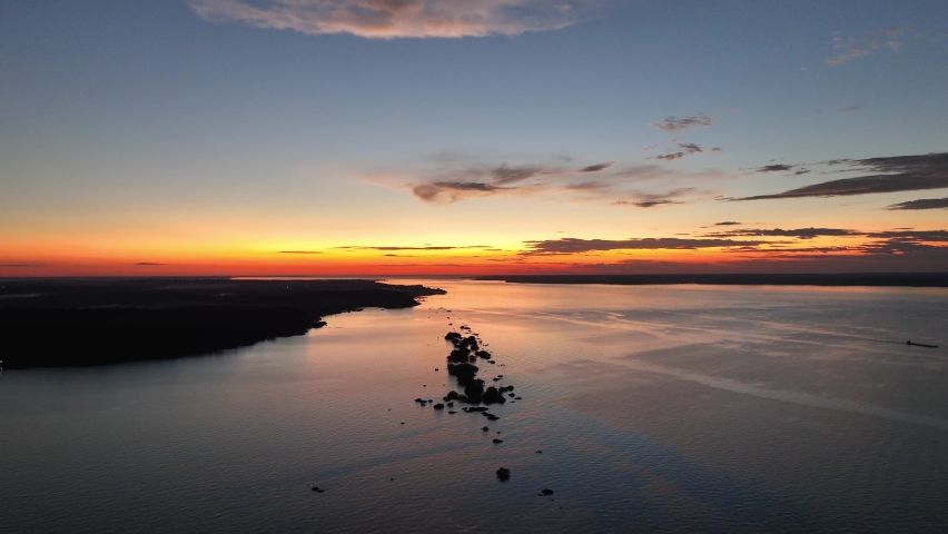 Sunset aerial view at Amazon River of Amazon Rainforest at town of Manaus Amazonas Brazil. Tourism landmark. Sunset nature scenery. Travel destinations. Black River at Amazon Forest Amazonas Brazil.