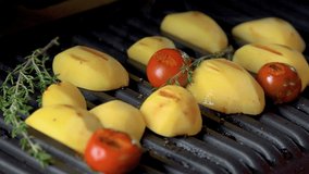 Hot delicious potato and tomatoes fried on electric grill