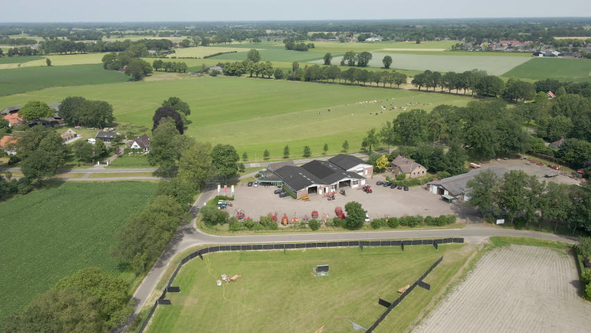 Aerial view of agricultural company with heavy machinery on lot