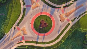 
Traffic speeding through roundabout intersection in American Heartland, time lapse aerial view.