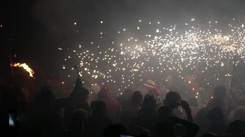 Palma de Mallorca, Spain; June 23rd 2022: Crowd of people dancing with demons and fireworks in the night of San Juan 2022 in Palma de Mallorca