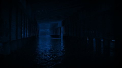 Moving Under Bridge With Water Flowing At Night