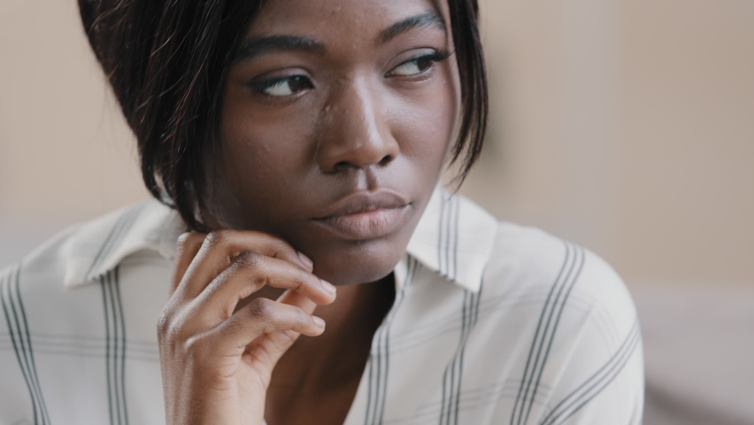 Close-up young african american woman sad worried girl feeling anxious sadness depressed upset female suffering from stress thinking of grief problem psychological disorder lost in depressive thoughts | Shutterstock HD Video #1091633007