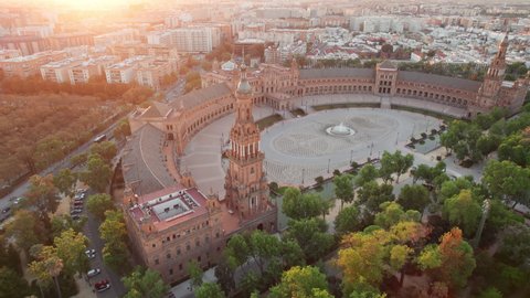 Plaza de Espana at sunrise in Seville, Spain. Revealing aerial shot of the famous Spanish Square and Maria Luisa park in the morning in Seville. Flying around historic Spanish square in Andalusia 