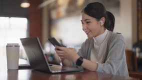 Adult female asia people happy smile sit easy relax work hybrid at cafes coffee shop enjoy play typing chat look at mobile phone buy or paying SME retail loan, post read review social media app online - Powered by Shutterstock - Get 15% off with code: PIKWIZARD15