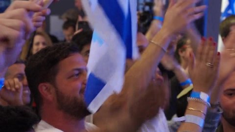 TEL AVIV, ISRAEL, April 9,2019 The Israeli Supporters of the Blue and White Party on election eve.
Happy crowd supporting, waving flags