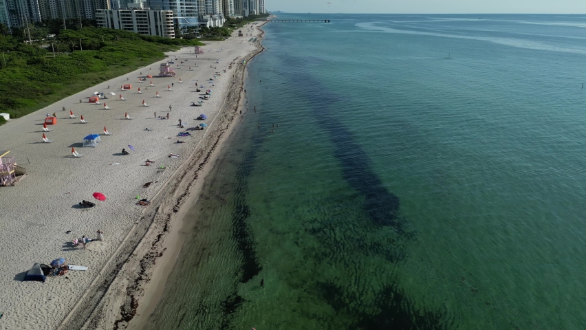 Aerial view of a flyover of the beach early in the morning.