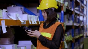 A beautiful female worker in uniform with her safety helmet on is holding scanner scanning parcel barcode in the warehouse store background. Inventory digitalization with barcode scanner concept. - Powered by Shutterstock - Get 15% off with code: PIKWIZARD15