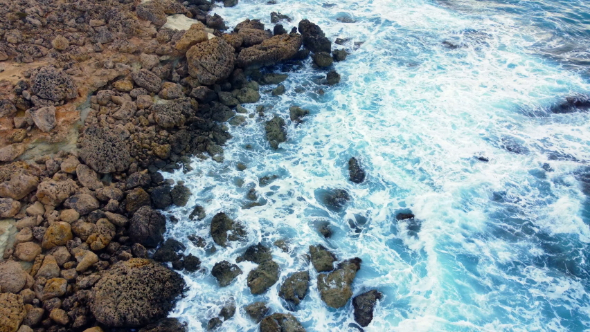 Sea waves washes the rocky shore, Above Aerial shot, Flying Over Coastline, Cliffside with Blue Pure Water, Ocean During Sunny weather. Bird Eye View 4K Cinematic Drone Footage, Cyprus | Shutterstock HD Video #1091654159